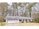 Charming single-story home with an attached two-car garage and a well-maintained front yard at 566 Sugar Valley Lane, Conyers, GA 30094