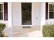 Close up of a front entrance with white pillars and a black door at 566 Sugar Valley Lane, Conyers, GA 30094