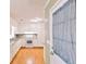 Bright kitchen featuring white cabinetry, modern appliances, and hardwood floors at 566 Sugar Valley Lane, Conyers, GA 30094