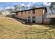 Back exterior of a brick home featuring a walkout basement, fenced yard, and mature trees at 405 Dan Se Pl, Smyrna, GA 30082