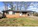 Charming brick home featuring a covered carport and welcoming front door decor at 405 Dan Se Pl, Smyrna, GA 30082