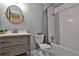 Well-lit bathroom featuring a modern vanity, a tiled shower, and a toilet with modern fixtures at 571 Tahoe Cir, Stone Mountain, GA 30083