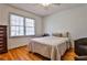 Cozy bedroom featuring hardwood floors, a ceiling fan, and a comfortable queen-sized bed at 571 Tahoe Cir, Stone Mountain, GA 30083