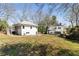 Expansive backyard with lush green lawn, mature trees, and a detached two-story building at 818 Springdale Ne Rd, Atlanta, GA 30306