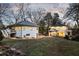 Large backyard with lush lawn, mature trees, and a detached two-story building at 818 Springdale Ne Rd, Atlanta, GA 30306