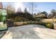 Picturesque backyard featuring a stone patio, lush landscaping, and mature trees at 818 Springdale Ne Rd, Atlanta, GA 30306