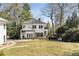 Spacious backyard featuring a well-maintained lawn, mature trees, and a charming patio area at 818 Springdale Ne Rd, Atlanta, GA 30306