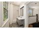 Well-lit bathroom with stylish vanity, shower with curtain and attractive herringbone tile at 818 Springdale Ne Rd, Atlanta, GA 30306