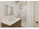 Bright bathroom with a modern vanity, an illuminated mirror, and a tiled shower with a rainfall showerhead at 818 Springdale Ne Rd, Atlanta, GA 30306
