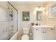 Updated bathroom showcasing a shower and tub, clean white cabinets and a Masters poster at 818 Springdale Ne Rd, Atlanta, GA 30306