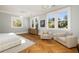 Spacious bedroom with large windows, beautiful hardwood floors, and stylish accent chairs at 818 Springdale Ne Rd, Atlanta, GA 30306