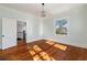 Bright bedroom featuring hardwood floors, modern light fixture, and white trim at 818 Springdale Ne Rd, Atlanta, GA 30306