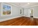Bright bedroom with hardwood floors, two windows, and neutral walls at 818 Springdale Ne Rd, Atlanta, GA 30306
