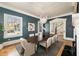 Sophisticated dining room featuring a modern chandelier, neutral-toned chairs, and blue accent walls at 818 Springdale Ne Rd, Atlanta, GA 30306