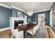 Formal dining room with a large table, stylish chandelier, and sophisticated blue walls at 818 Springdale Ne Rd, Atlanta, GA 30306