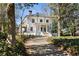 A two-story home with a prominent front porch framed by mature trees and established landscaping at 818 Springdale Ne Rd, Atlanta, GA 30306