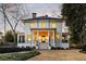Stately two-story home featuring a columned front porch, black framed windows, and landscaped yard at 818 Springdale Ne Rd, Atlanta, GA 30306