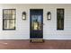 Inviting front door with sidelights and brick floor, framed by black framed windows at 818 Springdale Ne Rd, Atlanta, GA 30306