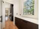 Hallway with dark cabinets, drawers, and natural light from a window at 818 Springdale Ne Rd, Atlanta, GA 30306