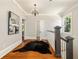 Inviting hallway showcasing hardwood floors, elegant lighting, and a stylish staircase at 818 Springdale Ne Rd, Atlanta, GA 30306