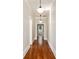 Hallway with hardwood floors and white trim with pendant lighting overhead at 818 Springdale Ne Rd, Atlanta, GA 30306
