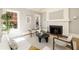 Cozy living room features a fireplace, white sofa, and ample natural light at 818 Springdale Ne Rd, Atlanta, GA 30306