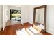 Bright living space with hardwood floors, large mirror, and doors opening to outdoor area at 818 Springdale Ne Rd, Atlanta, GA 30306