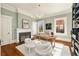 Bright office with a decorative fireplace and a large desk, illuminated by a modern chandelier at 818 Springdale Ne Rd, Atlanta, GA 30306