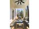 Inviting covered patio with a ceiling fan, stylish furniture, and serene views of the landscaped backyard at 818 Springdale Ne Rd, Atlanta, GA 30306
