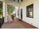 Outdoor patio with brick flooring, a black metal railing, and a great view of the surrounding trees at 818 Springdale Ne Rd, Atlanta, GA 30306