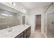 En-suite bathroom featuring double vanity, glass shower, and walk in closet at 1246 Allspice Way, Lawrenceville, GA 30045