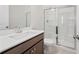 Bathroom with a shower behind a glass enclosure and a single sink vanity at 1246 Allspice Way, Lawrenceville, GA 30045