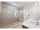 Bright bathroom with a dual sink vanity and a tiled walk-in shower with a glass enclosure at 1246 Allspice Way, Lawrenceville, GA 30045