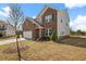 A charming two-story home featuring a brick and siding exterior and a well-manicured lawn at 1246 Allspice Way, Lawrenceville, GA 30045