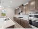 Modern kitchen with stainless appliances, range hood, gas cooktop and granite countertops at 1246 Allspice Way, Lawrenceville, GA 30045