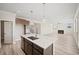 Open kitchen features a large island, stainless steel appliances, and seamless flow to the living area at 1246 Allspice Way, Lawrenceville, GA 30045