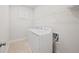 Bright laundry room with washer, dryer, and wire shelving at 1246 Allspice Way, Lawrenceville, GA 30045