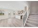 Open-concept living space with a modern kitchen, natural light, and staircase at 1246 Allspice Way, Lawrenceville, GA 30045