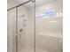 Modern walk-in shower with glass door, seat, and convenient built-in shelves at 1246 Allspice Way, Lawrenceville, GA 30045