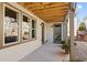View of back patio with windows, exterior door, wooden ceiling, and lush landscaped yard at 260 Hemphill Ln, Marietta, GA 30064