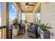 Charming back porch with comfortable wicker furniture, potted plants, and a ceiling fan at 260 Hemphill Ln, Marietta, GA 30064