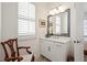 Elegant bathroom vanity area with sleek countertop, framed mirror, and ample natural light at 260 Hemphill Ln, Marietta, GA 30064