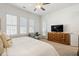 Bedroom boasts generous windows, a ceiling fan, and a stylish cabinet beneath the television at 260 Hemphill Ln, Marietta, GA 30064