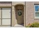 Close up of front door with brick surround and a decorative wreath at 260 Hemphill Ln, Marietta, GA 30064