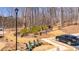 Parking lot with a wooded green space, log fence, and a black SUV at 260 Hemphill Ln, Marietta, GA 30064
