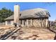 The home features a spacious backyard, chimney, patio, and wooden fence at 8000 Abington Dr, Locust Grove, GA 30248