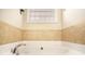 Bathroom with large tub with tile accents and chrome faucet at 8000 Abington Dr, Locust Grove, GA 30248