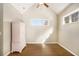 Empty bedroom with neutral walls, hardwood floor, vaulted ceiling, and a bright window at 8000 Abington Dr, Locust Grove, GA 30248