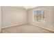 Empty bedroom with neutral carpet, and a hanging decorative light fixture at 8000 Abington Dr, Locust Grove, GA 30248