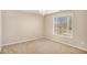 Neutral bedroom with carpet and window, enhanced by chandelier at 8000 Abington Dr, Locust Grove, GA 30248